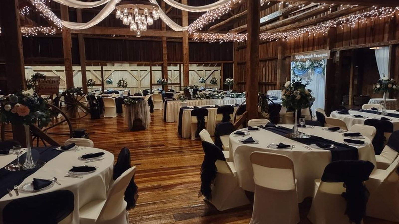 Fairman Family Farms barn reception interior with navy table settings
