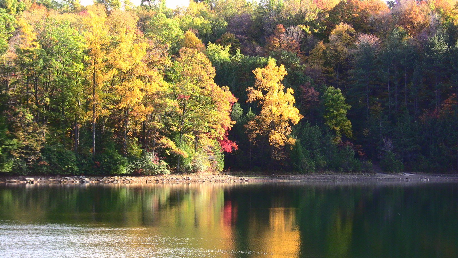 Indiana County lake with brilliant autumn foliage reflected in still water